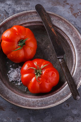 Fresh tomatoes on a vintage plate.selective focus