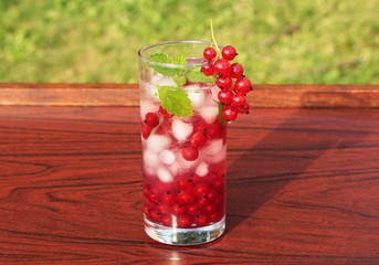 Refreshing summer drink with redcurrant and mint