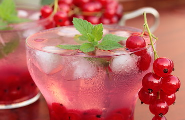 Refreshing summer drink with redcurrant and mint