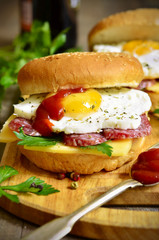 Burger with cheese,salami and fried egg.