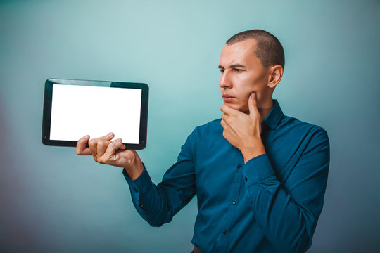 a man of European appearance thirty years, holding a tablet frow