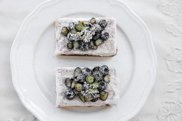 Classic Chester Cake slices with blueberries and Cilantro flower