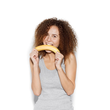  Young pretty woman making fun with banana