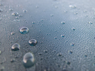 Water drops on glass on blue background