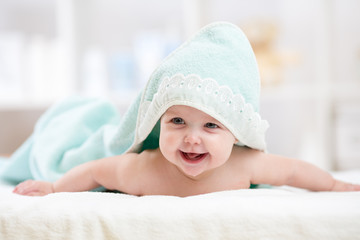 Fototapeta na wymiar happy baby under towel indoor
