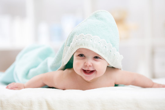 happy baby under towel indoor