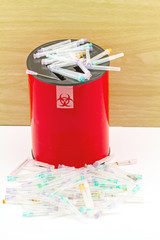 Many needle in red disposal boxes on white background