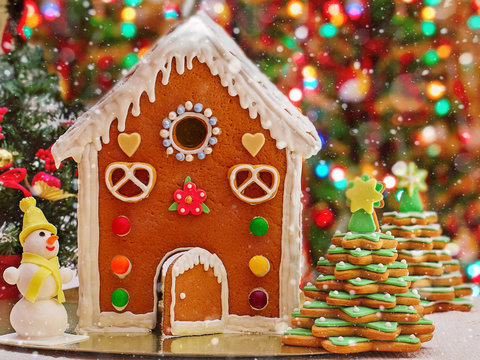 Gingerbread cookies (house, Christmas tree). Bokeh background.Snow effect.