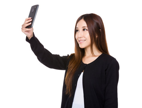 Asian Young woman take selfie by mobile phone