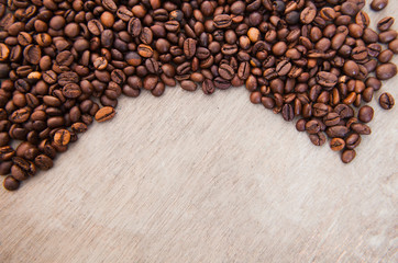 Roasted coffee beans on wooden background