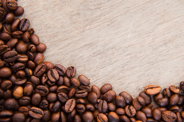 Roasted coffee beans on wooden background