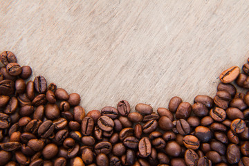 Roasted coffee beans on wooden background
