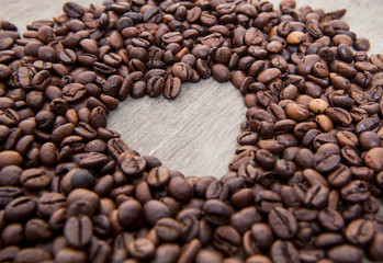 Heart symbol within roasted coffee beans