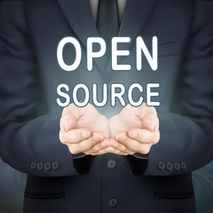 businessman holding open source words