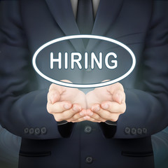 businessman holding hiring word