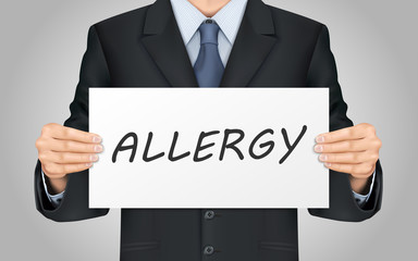 businessman holding allergy poster
