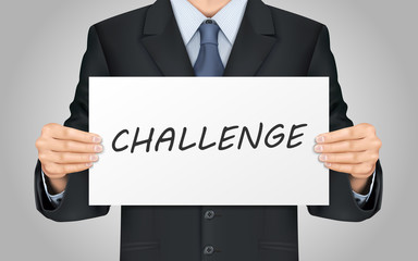 businessman holding challenge poster