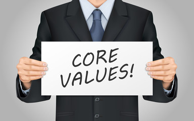 businessman holding core values poster