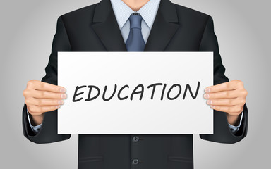 businessman holding education poster