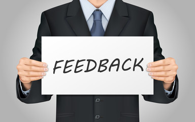 businessman holding feedback poster