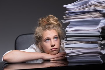 Girl overwhelmed by paperwork