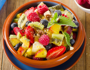 Healthy homemade fruit salad on   rustic background.
