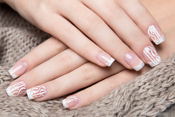 Snow White manicure on female hands. Winter nail design. 