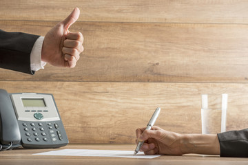 Businessman expressing his approval by making a thumbs up gestur