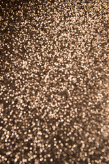 Bronze glitter background in defocus abstract