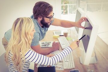 Woman pointing at computer with stylus 