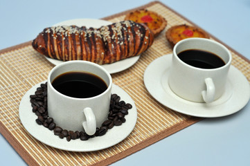 hot coffee with coconut tart and red bean bread on bamboo mat