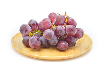 Purple grapes fruits in wooden dish isolated on white background