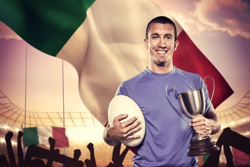 Composite image of portrait of smiling rugby player