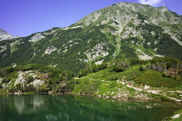 Reflection of Hvoynati peak in Okoto lake, Pirin Mountain, Bulgaria