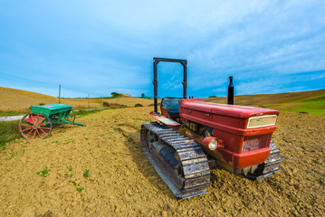 Fototapeta premium Red tractor on caterpillars on the autumn fields