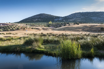 Fototapeta na wymiar The Bullaque River at its pass through Porzuna, La Mancha, Ciudad Real, Spain