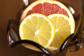 sliced grapefruit and lemon lying in a vase