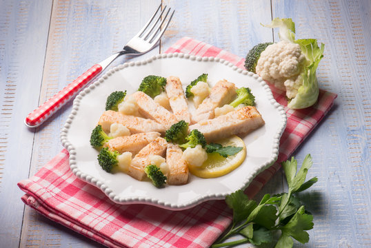 sliced swordfish with broccoli and cauliflower salad