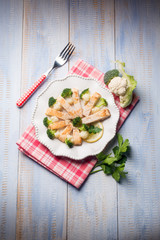 sliced swordfish with broccoli and cauliflower salad