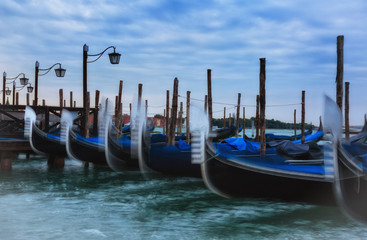 Fototapeta na wymiar Venice, gondolas on Grand Canal early in the morning before sunrise