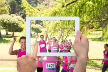 Obraz premium Composite image of hand holding tablet pc