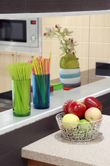 Modern kitchen room with Straws in glass and fruit on counter