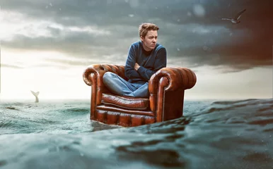 Foto op Canvas Man on a seat lost at sea © lassedesignen
