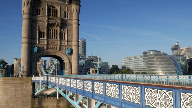 Tilt down from the South Tower of Tower Bridge to the road. Taken on Tower Bridge on a sunny autumn morning in 4K. City Hall is seen in the background