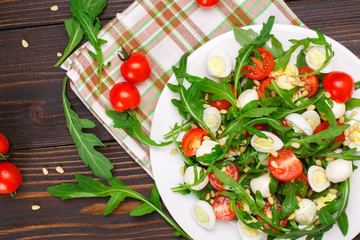 Salad with arugula on a wooden background