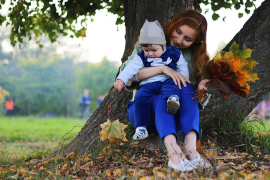 redhead girl with son Autumn leaves