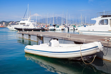 Fototapeta premium White motorboat floats moored in marina, Ajaccio