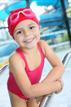Portrait of 4-year-old girl bathing in swimming pool