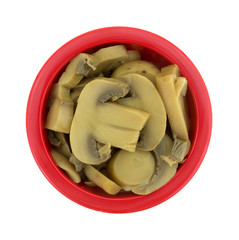 Canned mushroom pieces in a small red bowl