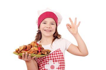 happy little girl with chicken drumstick and ok hand sign